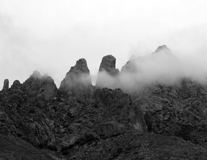 black and white photo of clouds enveloping the Rabbit Ears peaks
